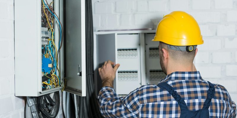 Male electrician repairing circuit line